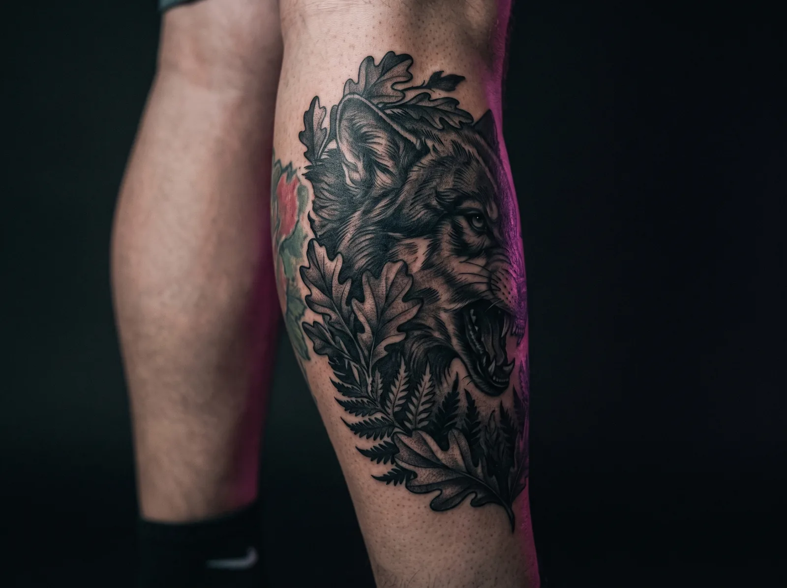 Bold black and grey animal redesign covering an old faded color tattoo