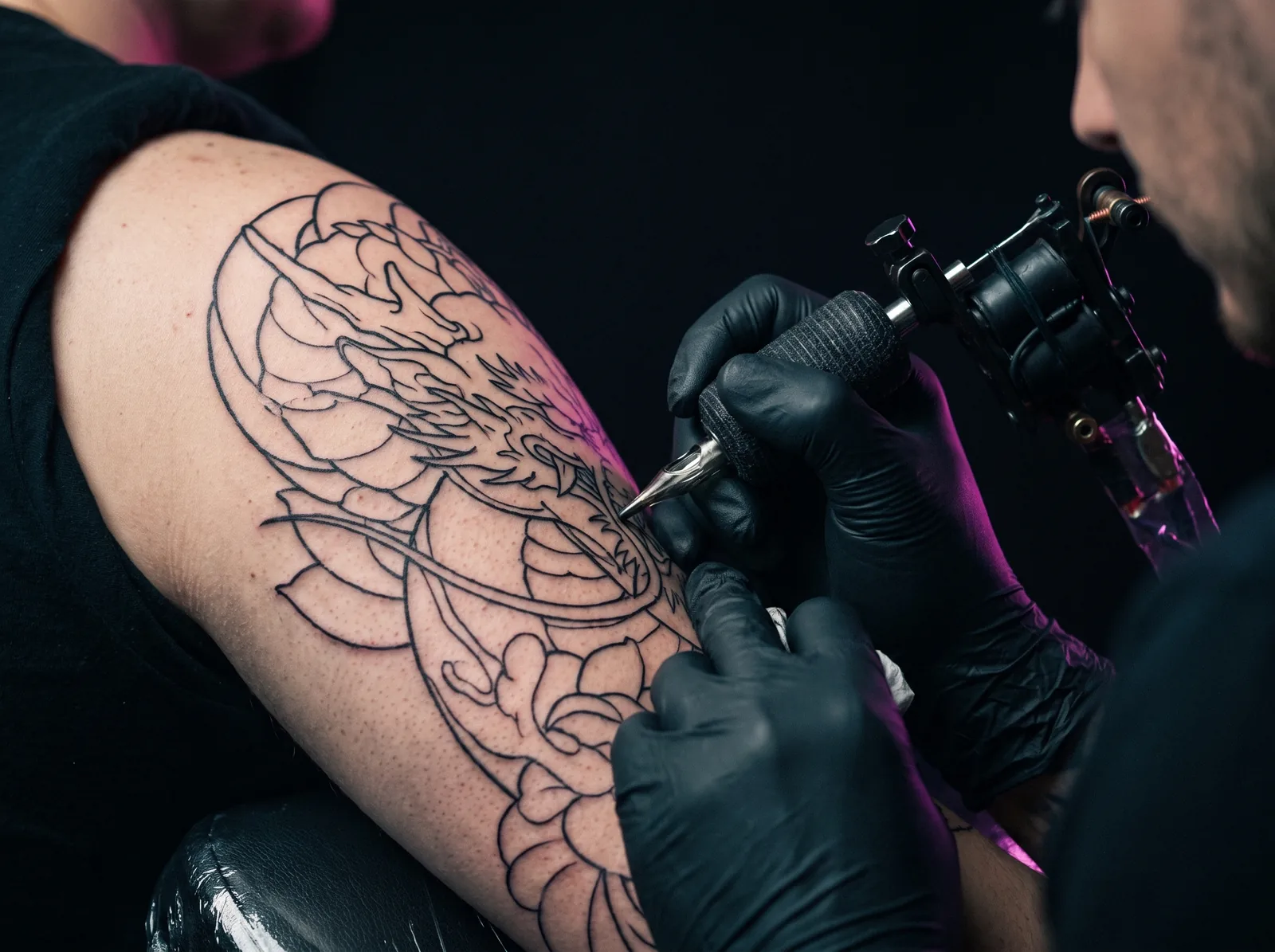 Fresh sleeve tattoo outline linework laid down during a first session