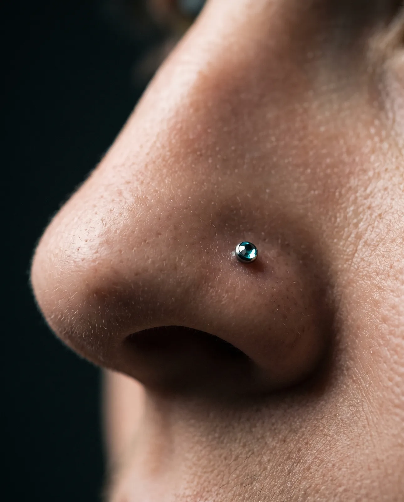 Close-up of a healed nostril stud piercing
