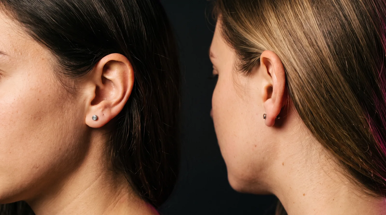 Close-up of matching titanium lobe piercing jewelry on two friends