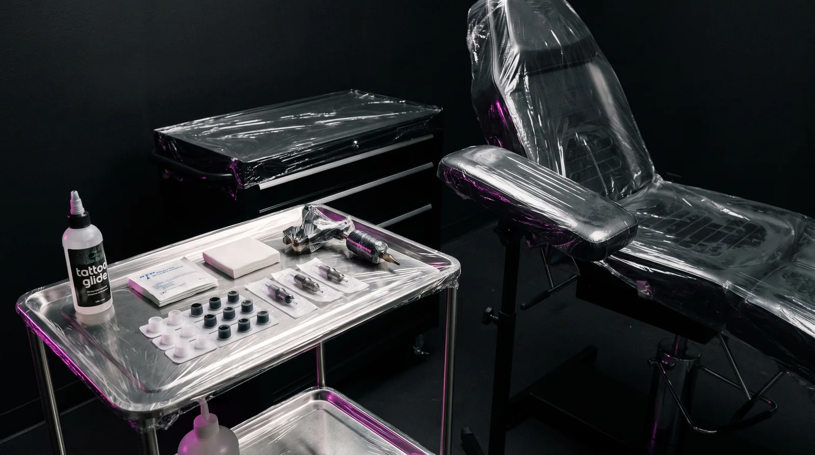 Tattoo workstation prepared with sterile single-use barrier setup ahead of a session
